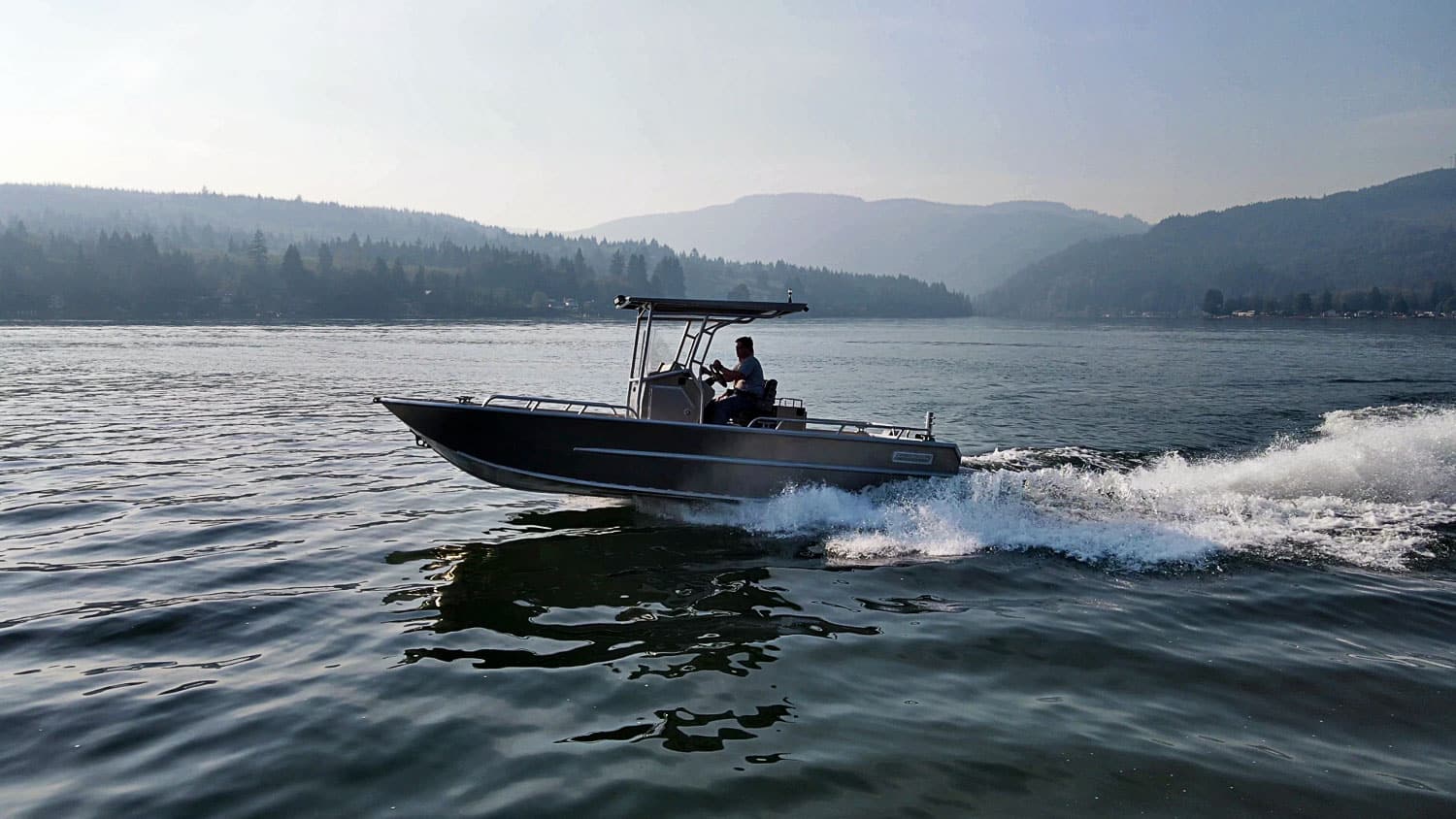 Our pro aluminum jet boat takes off in the water, leaving a trail of water spraying behind