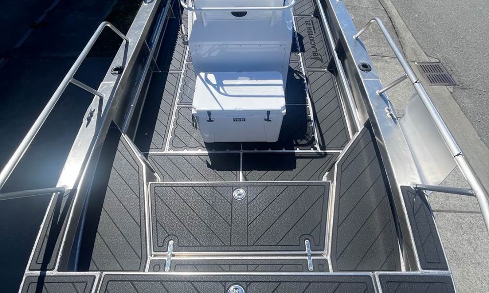 Top view of the deck on our Blackfish aluminum center console boat. There is black patterned no-slip SeaDek flooring installed.