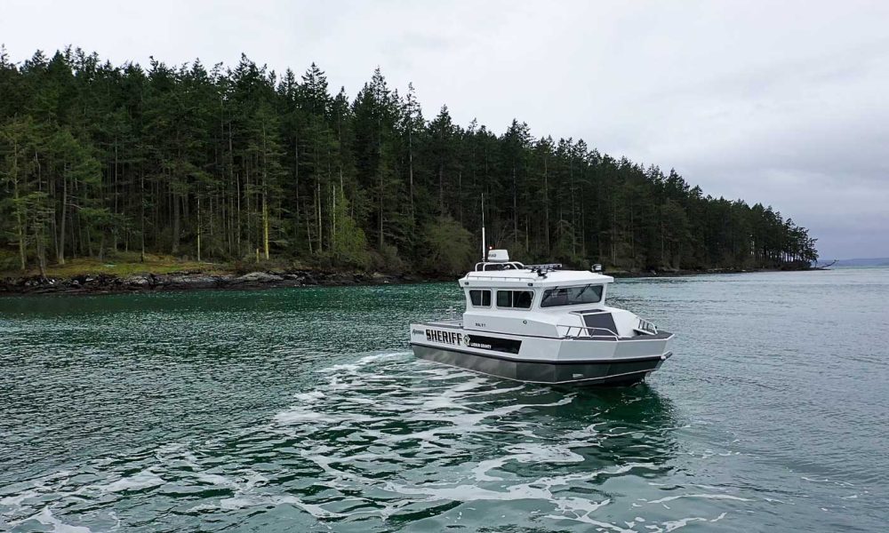 Our Sentinel patrol boat on the water with a line of trees in the background
